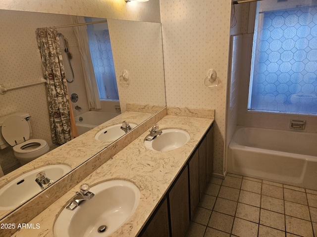 full bathroom featuring tile patterned floors, wallpapered walls, and a sink