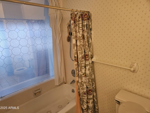 full bathroom featuring wallpapered walls, shower / tub combo, and toilet