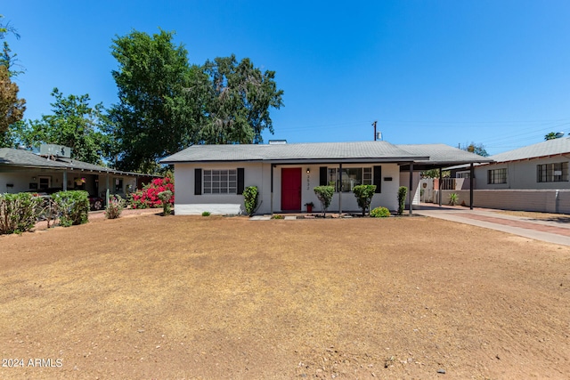 ranch-style home with a front lawn