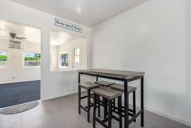 dining space featuring tile patterned flooring and ceiling fan