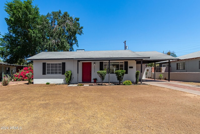 single story home featuring a front yard and a carport