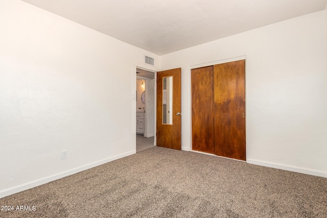 unfurnished bedroom with a closet and carpet