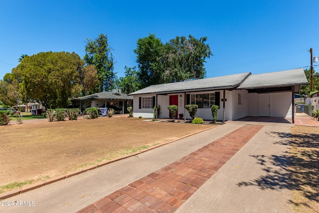 ranch-style home with a carport and a front yard