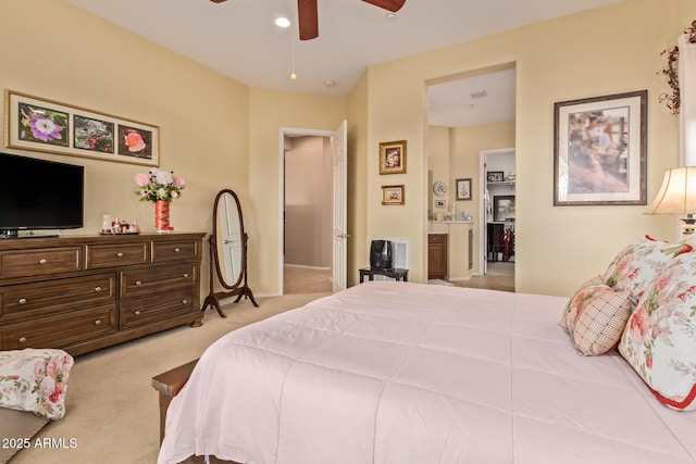 carpeted bedroom with ceiling fan and connected bathroom