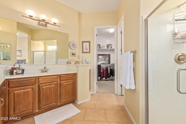 bathroom featuring vanity, tile patterned flooring, and walk in shower