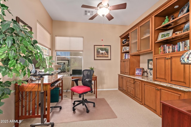 carpeted office space with ceiling fan