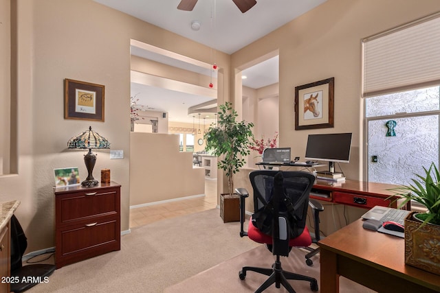 home office with ceiling fan, light colored carpet, and plenty of natural light