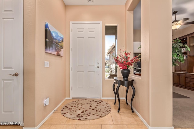 tiled entrance foyer with ceiling fan