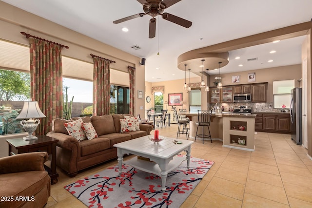 living room with ceiling fan and light tile patterned floors