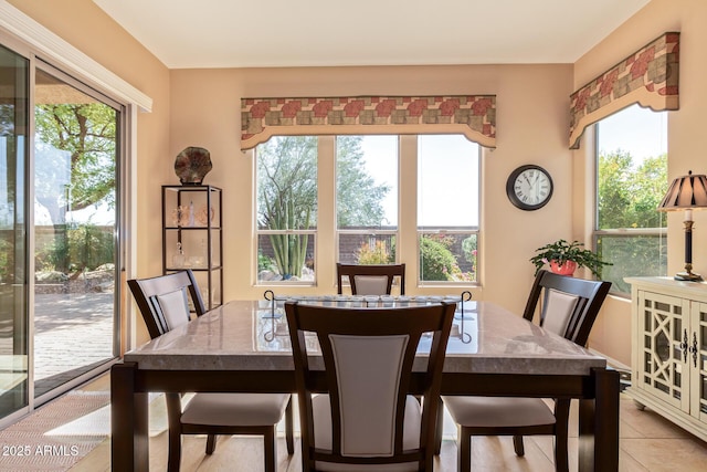 dining space featuring light tile patterned floors