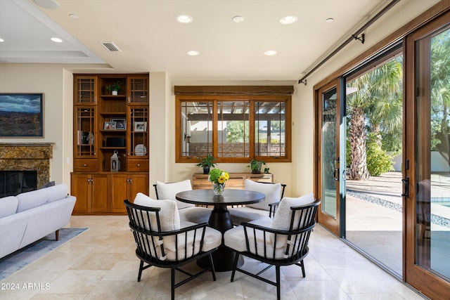 dining area featuring a fireplace and a healthy amount of sunlight