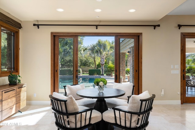 tiled dining room featuring a healthy amount of sunlight