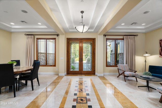 entryway with a healthy amount of sunlight, french doors, and a tray ceiling