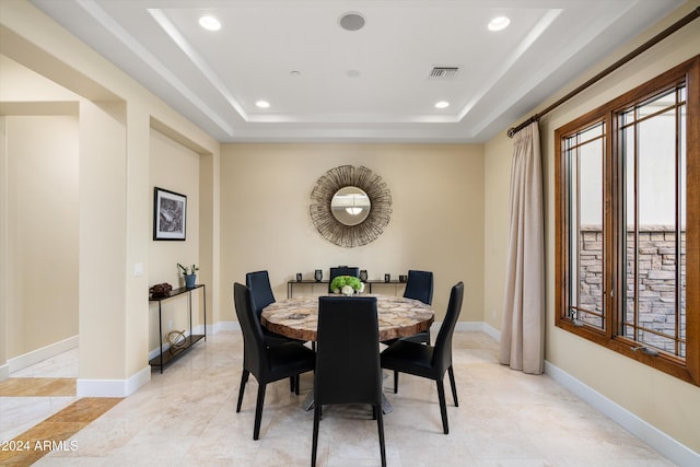 dining space featuring a tray ceiling