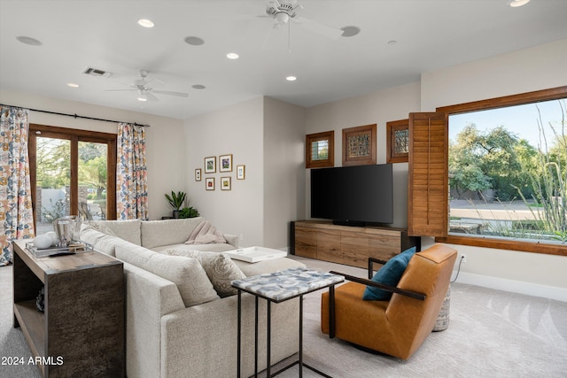 carpeted living room featuring ceiling fan