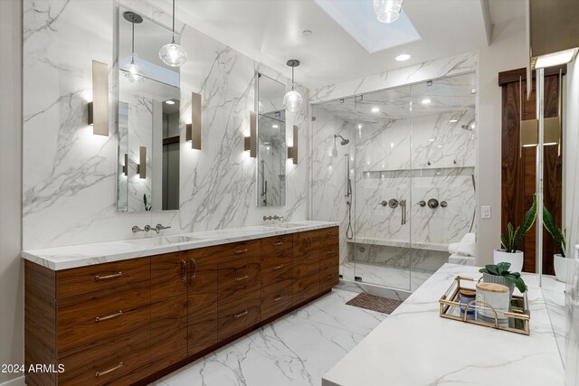 bathroom featuring a skylight, vanity, tile walls, and walk in shower