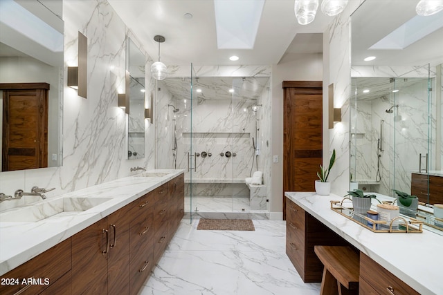 bathroom with a skylight, vanity, and a shower with shower door