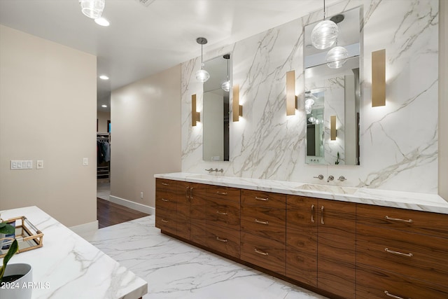 bathroom featuring vanity and tile walls