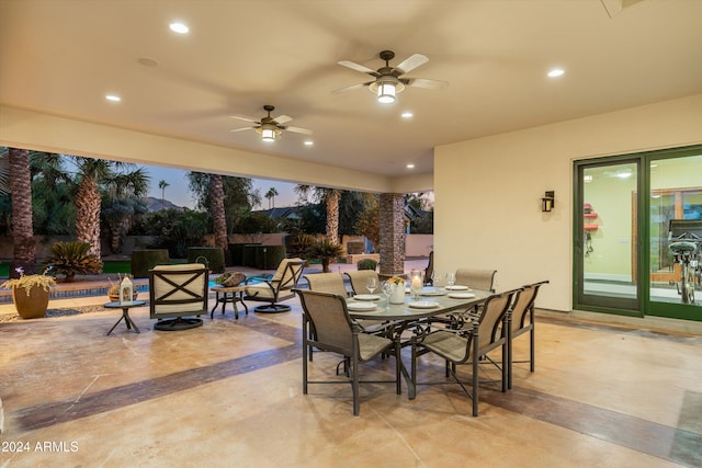 patio terrace at dusk featuring ceiling fan