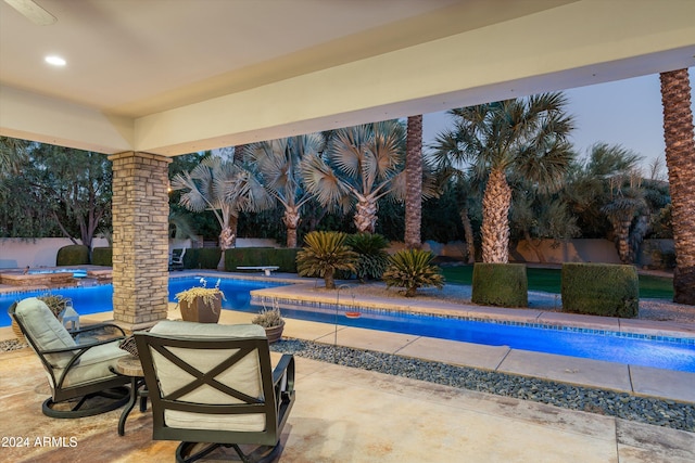 view of pool featuring a patio and a hot tub