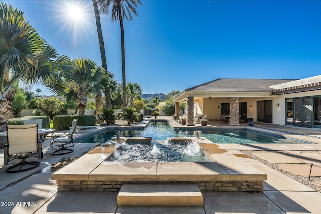 view of pool with pool water feature and a patio