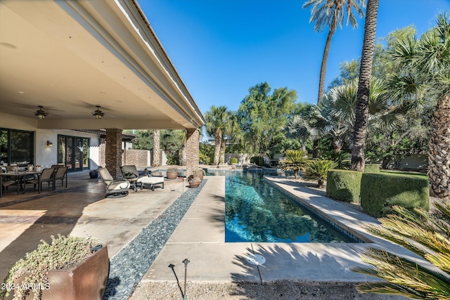 view of pool with ceiling fan and a patio