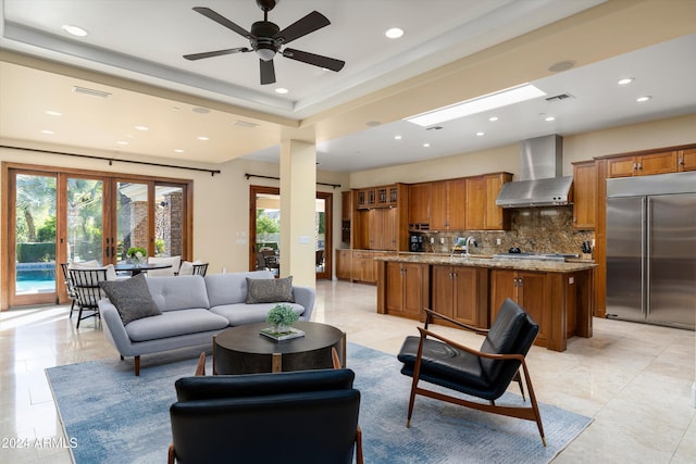 tiled living room with ceiling fan and french doors