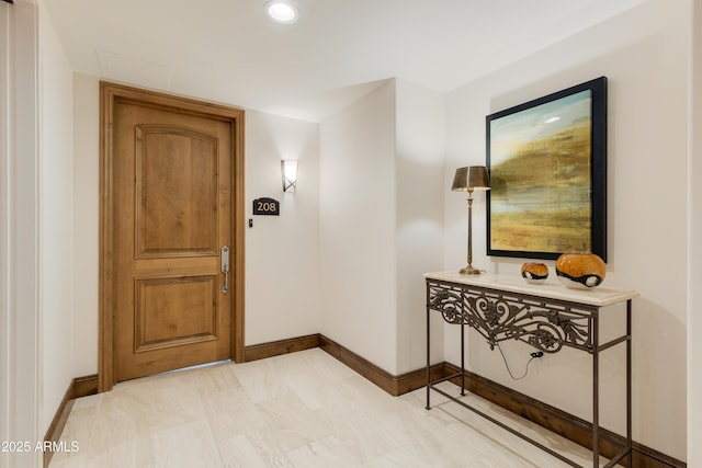 hall featuring recessed lighting and baseboards