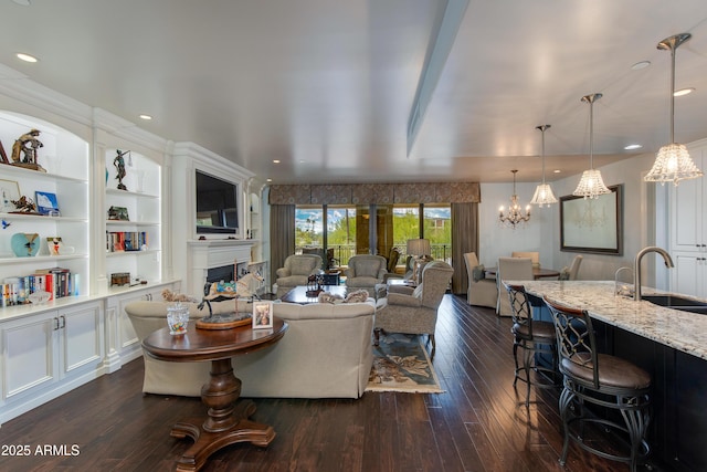 living area with recessed lighting, built in shelves, dark wood-style floors, and a fireplace