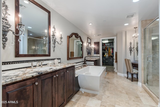 full bath featuring a spacious closet, visible vents, a shower stall, and vanity