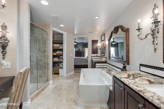 full bath featuring a stall shower, recessed lighting, a bathtub, ceiling fan, and vanity