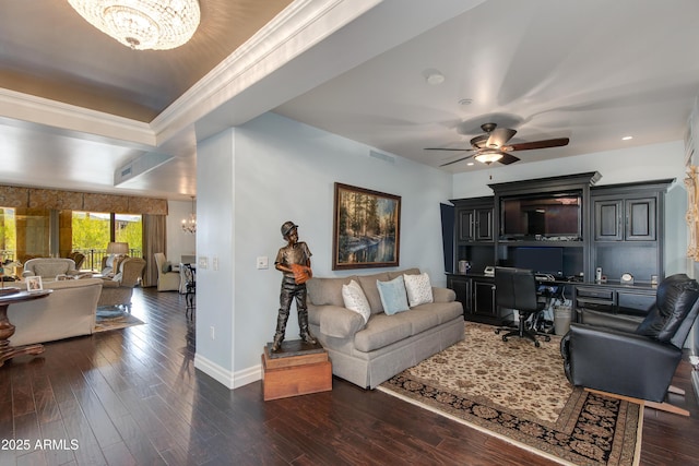 living room featuring visible vents, dark wood-type flooring, baseboards, built in desk, and ceiling fan with notable chandelier