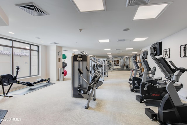 exercise room featuring light carpet and visible vents