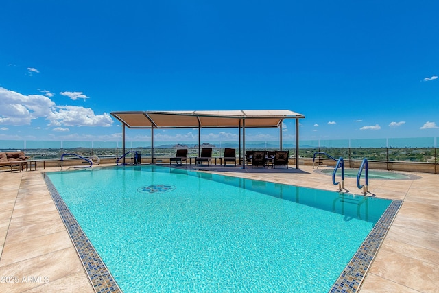 pool with a patio and fence