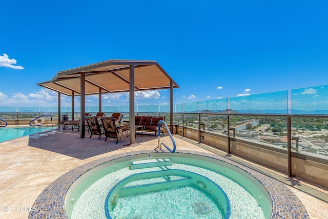 view of pool with a mountain view, an outdoor hangout area, a fenced in pool, and an in ground hot tub