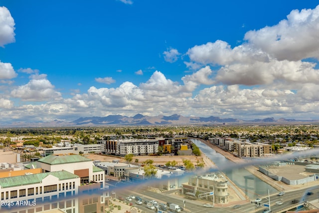 drone / aerial view featuring a view of city and a mountain view