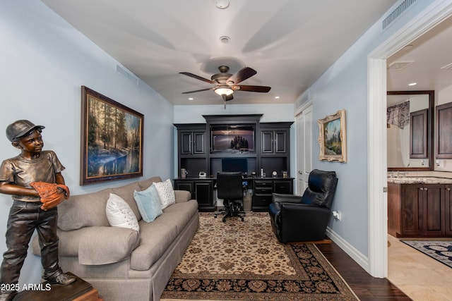 office area featuring baseboards, a ceiling fan, visible vents, and built in study area