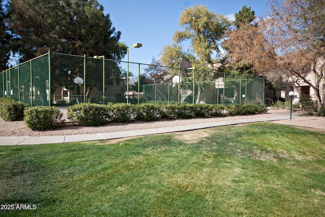 surrounding community with basketball court and a lawn