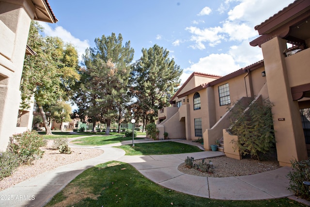 view of home's community with a lawn