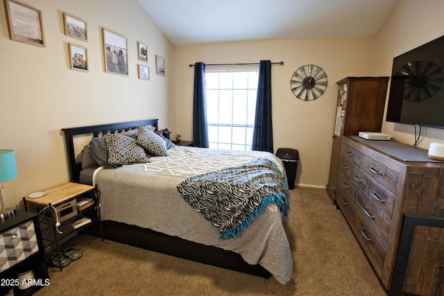 bedroom with light carpet and lofted ceiling