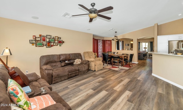 living room with ceiling fan and dark hardwood / wood-style floors