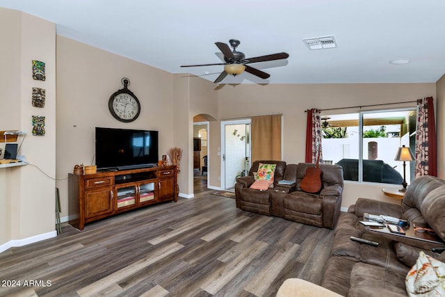 living room with lofted ceiling, ceiling fan, and dark wood-type flooring