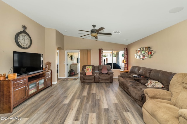 living room with ceiling fan, hardwood / wood-style flooring, and lofted ceiling