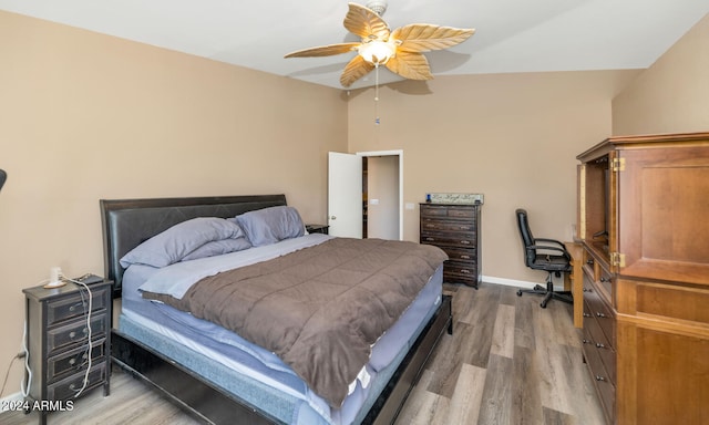 bedroom with ceiling fan, lofted ceiling, and hardwood / wood-style floors