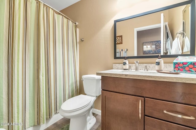 bathroom with hardwood / wood-style floors, vanity, toilet, and a shower with curtain