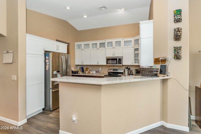 kitchen featuring decorative backsplash, white cabinets, kitchen peninsula, stainless steel appliances, and hardwood / wood-style floors