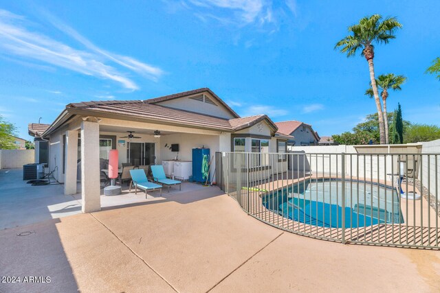 view of swimming pool featuring ceiling fan, a patio, and central AC