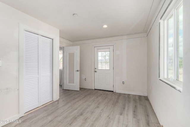 entryway featuring baseboards, recessed lighting, and light wood-style floors