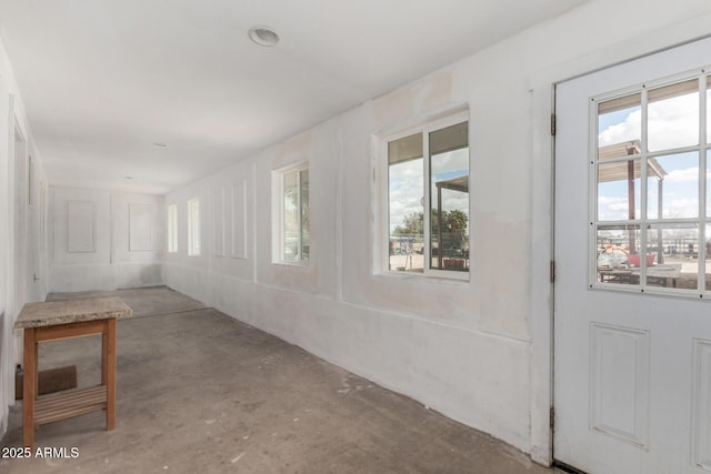 interior space featuring unfinished concrete flooring