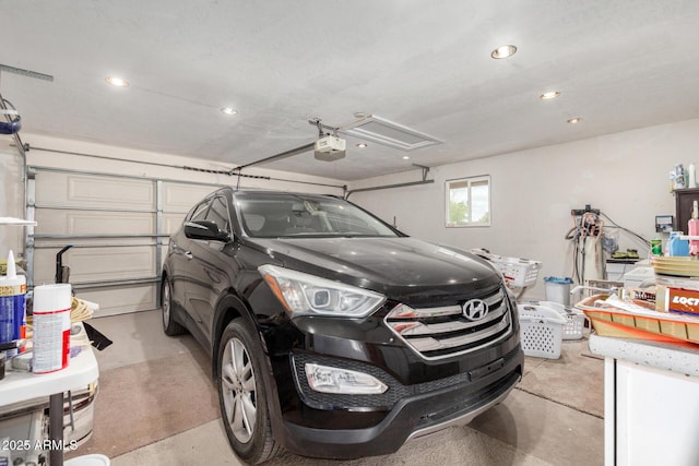 garage with a garage door opener and recessed lighting